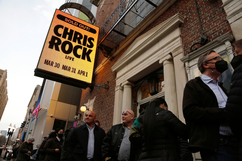 Ticket holders wait to enter the Wilbur Theatre for a performance by Chris Rock, Wednesday, March 30, 2022, in Boston. (AP Photo/Mary Schwalm)