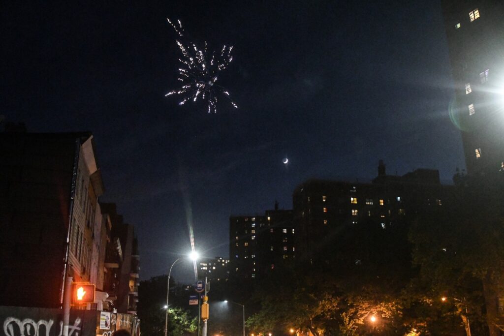 NEW YORK, NY - JUNE 24: A person records with a phone a fireworks display in an empty park on June 24, 2020 in the Brooklyn borough in New York City. According to New York City officials, complaints about fireworks have skyrocketed in recent weeks. (Photo by Stephanie Keith/Getty Images)