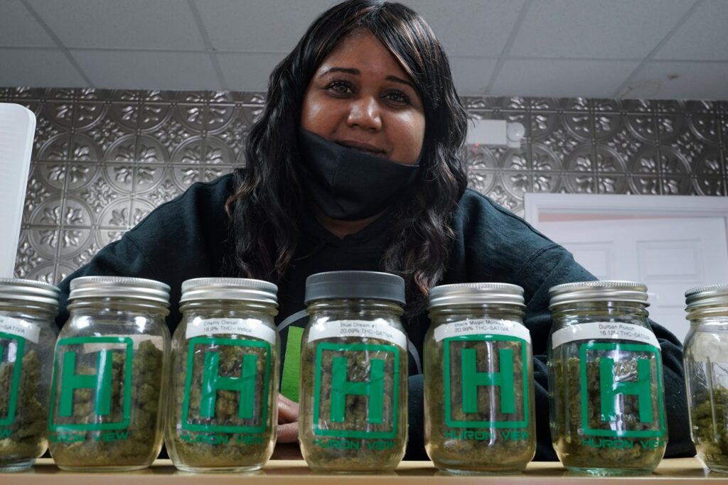 Teesha Montague works at Huron View Provisioning in Ann Arbor, Mich., Thursday, Jan. 28, 2021. The first year of state-licensed recreational marijuana sales in Michigan saw $511 million of sales in recreational and $474 million in medical sales, generating over $100 million in tax revenue, but the state also found that the industry drastically failed to attract minority business owners. (AP Photo/Paul Sancya)