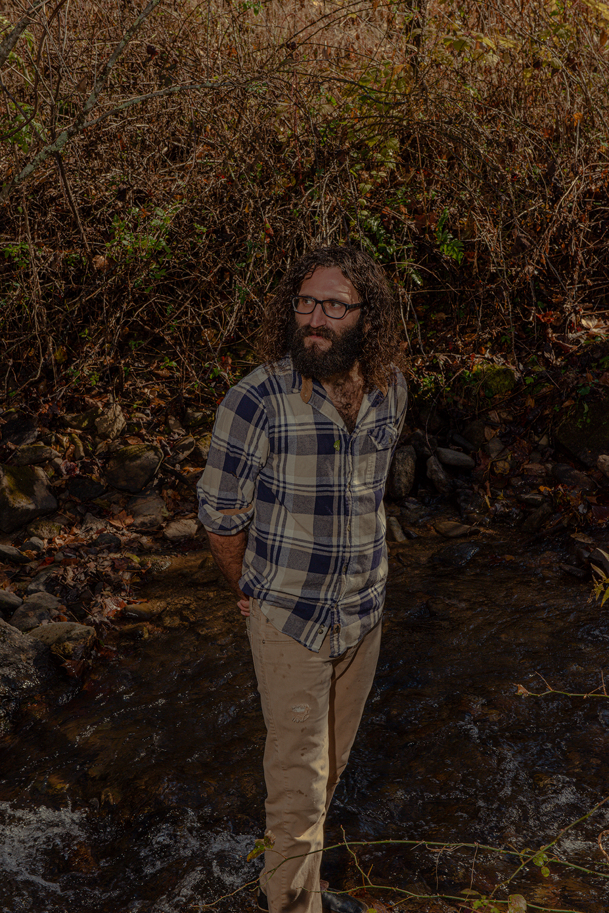 CANDLER, NC -- November 12, 2021:Noah Kalos stands for a portrait outside his home in Candler, North Carolina on Friday, November 12, 2021. Kalos is a mycologist and audio video synthesist in western North Carolina. CREDIT: Jacob Biba for Rolling Stone