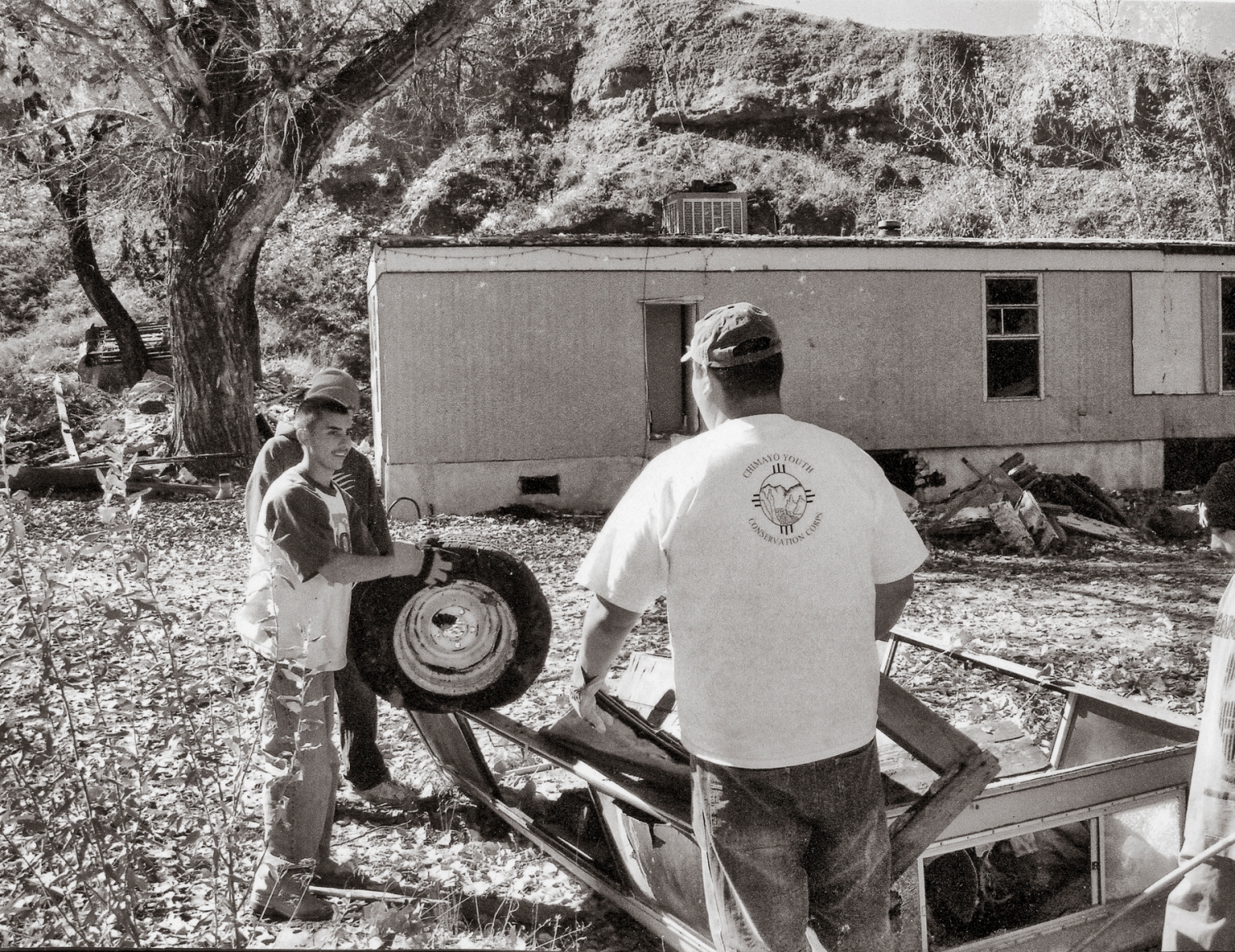 A 2005 photo of employees and a counselor from the Chimayó Youth Conservation Corps at work on a clean-up of the Barela property. The land was confiscated after 1999 and transferred to Rio Arriba County, which allowed the youth corps to use it.