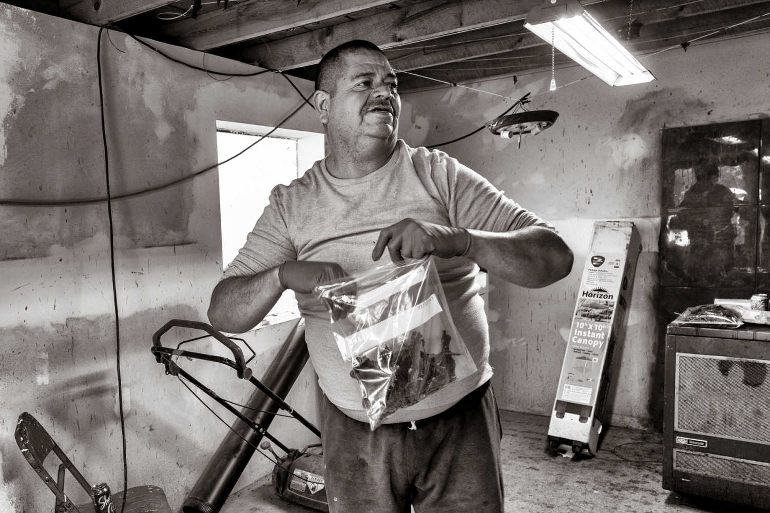Placedes “Prax” Martinez packs a bag with dried elk meat in an outbuilding on his property in Chimayó. Now drug-free for more than 10 years, he began selling heroin as a teenager, alongside his relatives.
