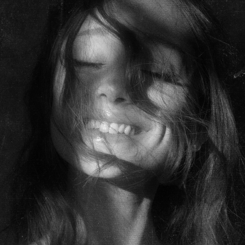 Image may contain Face Head Person Photography Portrait Happy Smile Body Part Mouth Teeth Adult and Laughing